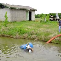 Golf course wet well intake maintenance diver in pond