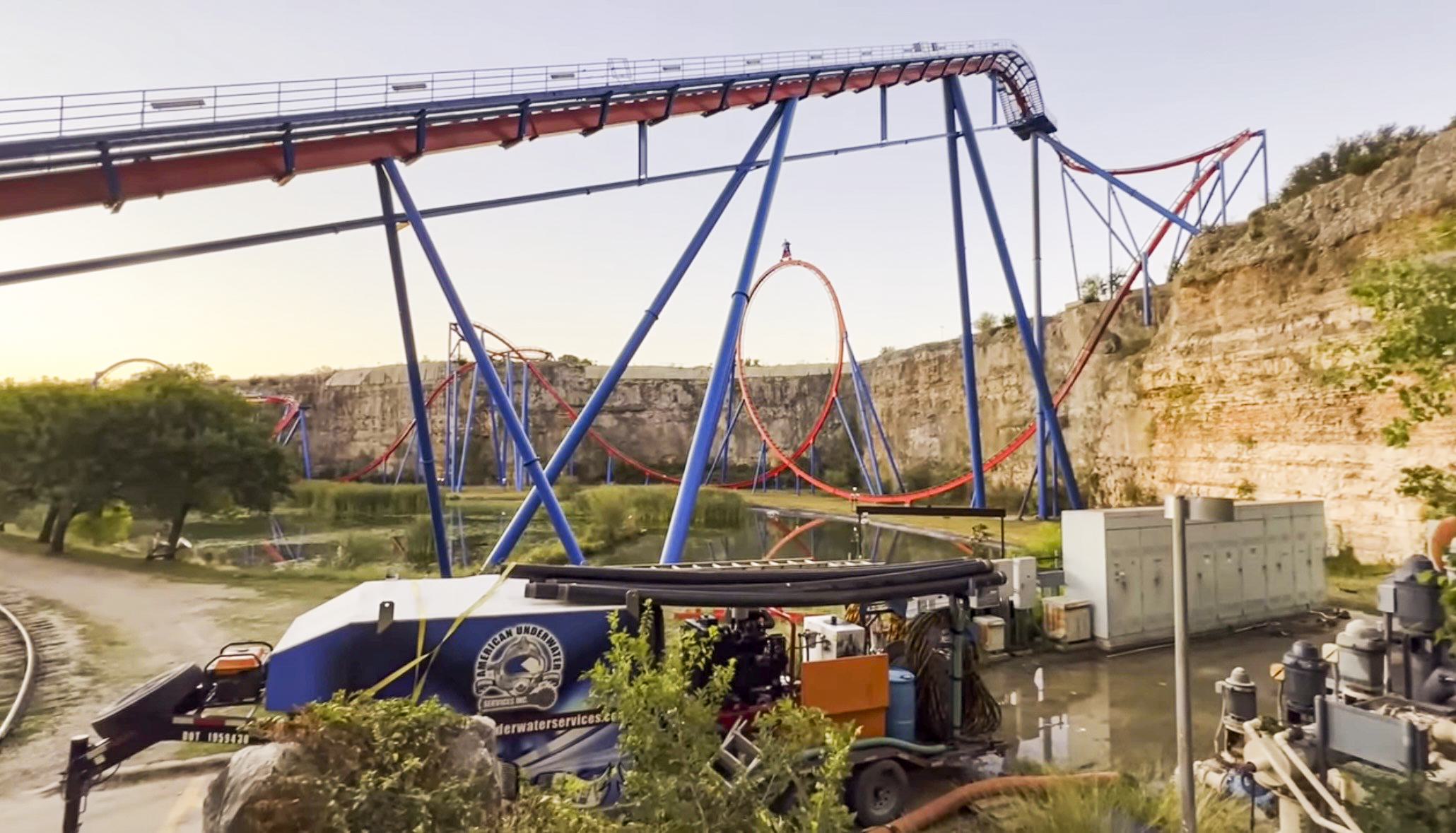 A pond dredge set up in front of Six Flags Roller Coaster